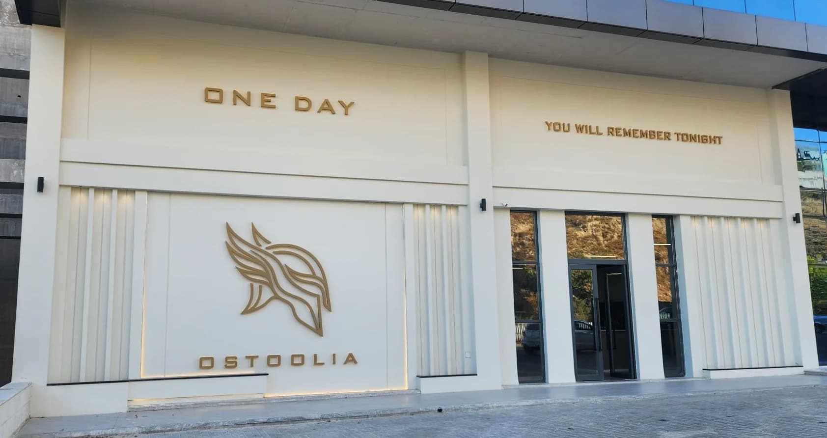 The finished Ostoolia facade on Arar Street — ONE DAY / YOU WILL REMEMBER TONIGHT in gold above the door